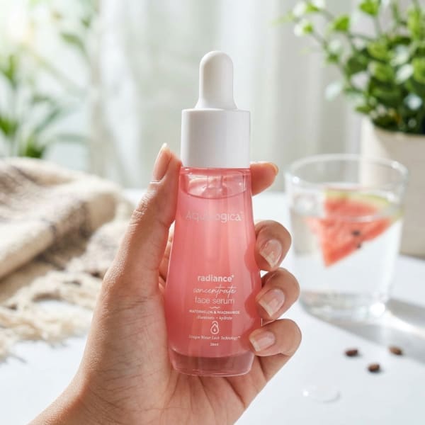 Aqualogica FREEBIE - Radiance+ Concentrate Face Serum 30 ml held in hand, candid photo