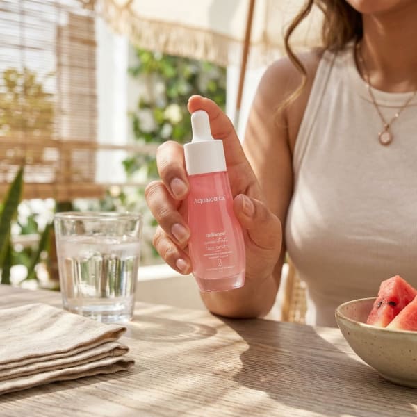 Aqualogica FREEBIE - Radiance+ Concentrate Face Serum 30 ml held in hand, candid photo