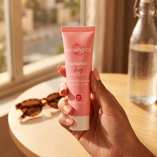 Aqualogica FREEBIE Radiance+ Dewy Sunscreen held in hand, candid photo