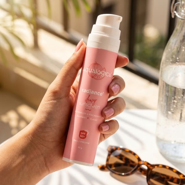 Aqualogica FREEBIE Radiance+ Dewy Sunscreen, 50g held in hand, candid photo