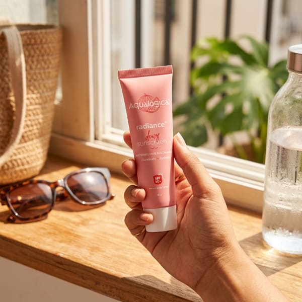 Aqualogica FREEBIE - Radiance+ Dewy Sunscreen held in hand, candid photo
