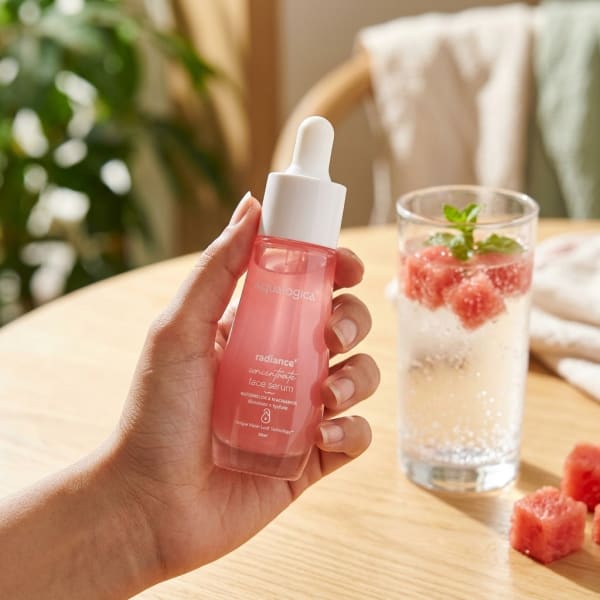 Aqualogica FREEBIE_Radiance+ Concentrate Face Serum 30 ml held in hand, candid photo