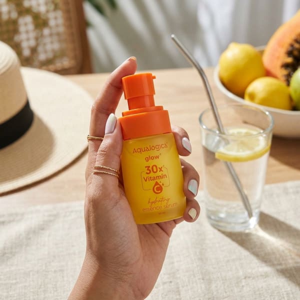 Aqualogica FREEBIE - Glow+ 30X* Vitamin C Hydrating Essence Serum- 50ml held in hand, candid photo