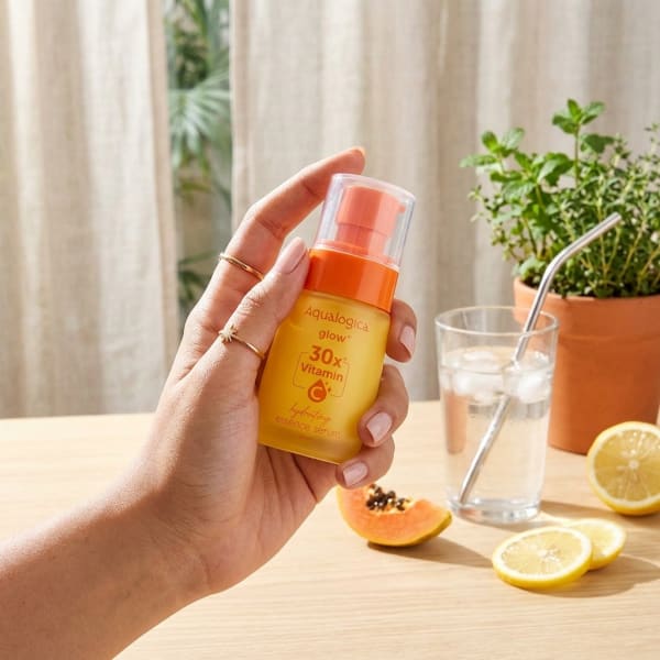 Aqualogica Glow+ 30X* Vitamin C Hydrating Essence Serum- 50ml held in hand, candid photo