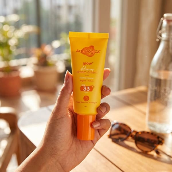 Aqualogica Glow+ 3-in-1 Delicious Dream Cream with SPF 33+ & PA+++ for Glowing Skin - 50g held in hand, candid photo