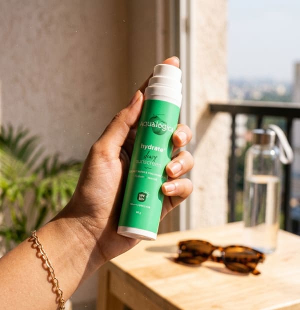 Aqualogica Hydrate+ Dewy Sunscreen 50g held in hand, candid photo