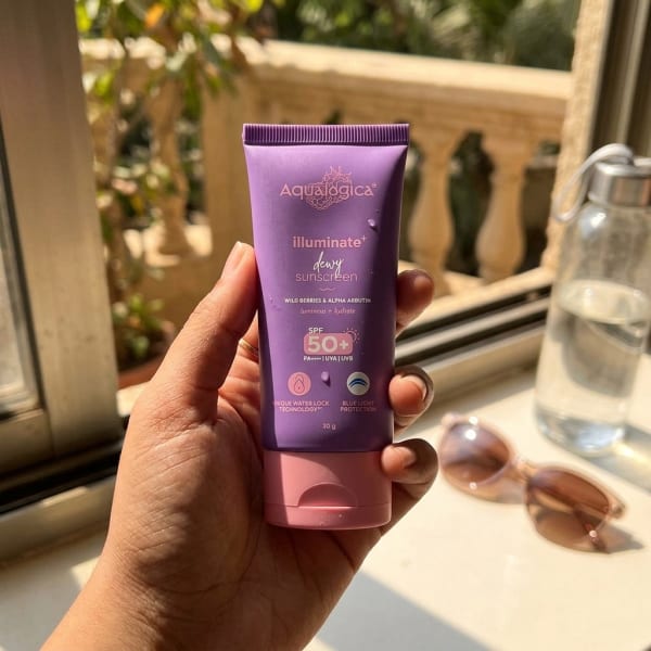 Aqualogica Illuminate+ Dewy Sunscreen In-Vivo Tested SPF 50+ PA++++ with Wild Berries & Alpha Arbutin - 30 g held in hand, candid photo