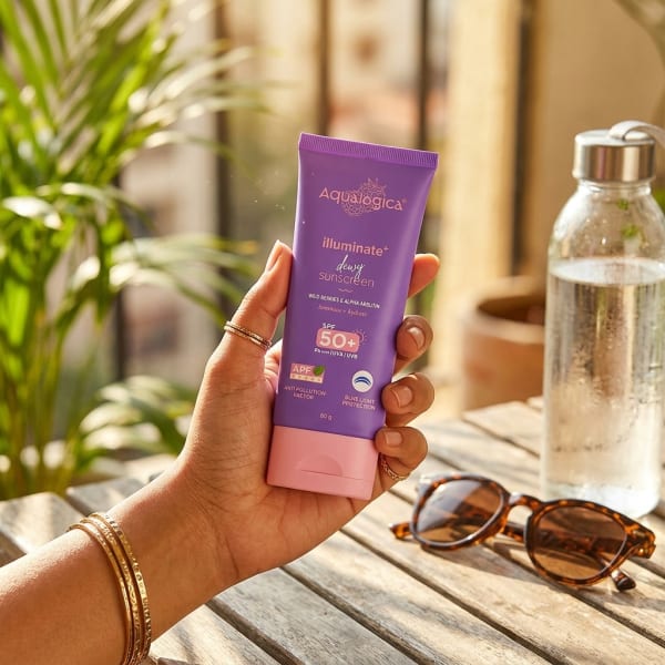 Aqualogica Illuminate+ Dewy Sunscreen In-Vivo Tested SPF 50+ PA++++ with Wild Berries & Alpha Arbutin - 80 g held in hand, candid photo