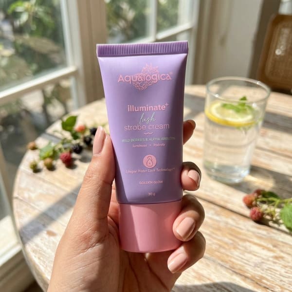 Aqualogica Illuminate+ Lush Strobe Cream with Wild Berries & Alpha Arbutin for Instant HD Glow - 30g held in hand, candid photo