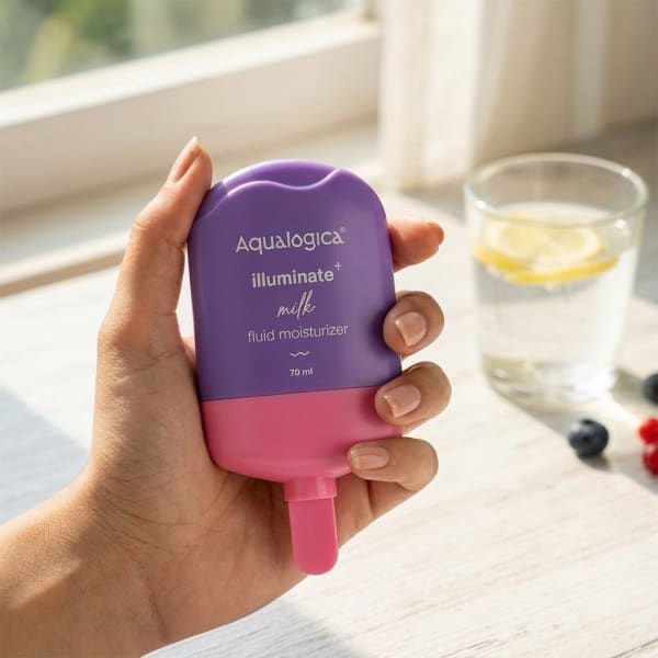 Aqualogica Illuminate+ Milk Fluid Moisturizer - 70ml held in hand, candid photo