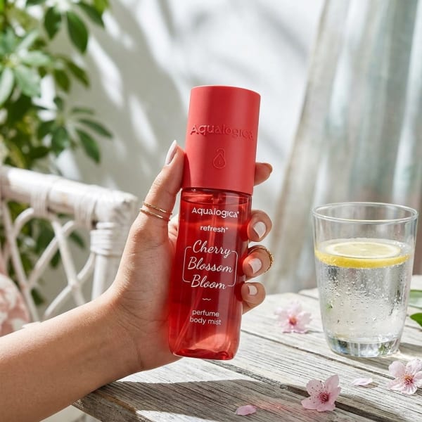 Aqualogica Refresh+ Cherry Blossom Bloom Perfume Body Mist with Zemea and Hyaluronic Acid 150 ml held in hand, candid photo