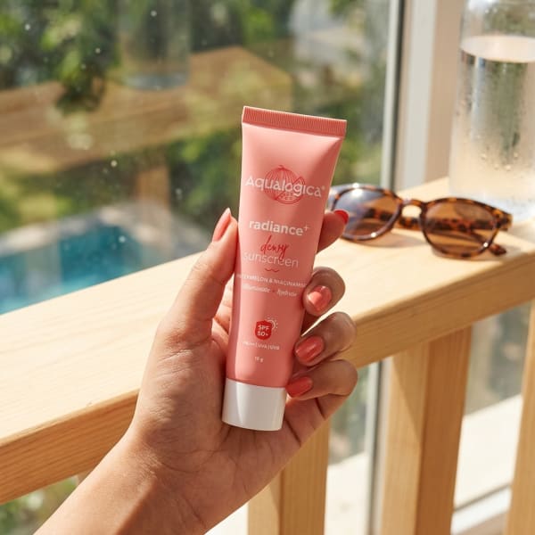 Aqualogica FREEBIE Radiance+ Dewy Sunscreen held in hand, candid photo