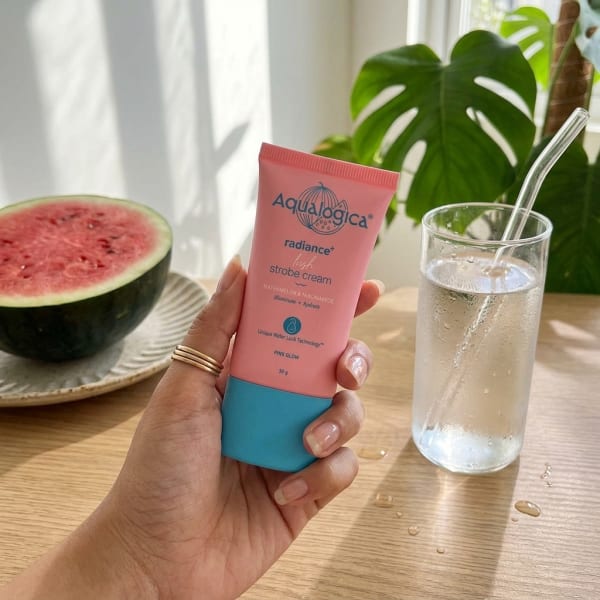 Aqualogica Radiance+ Lush Strobe Cream with Watermelon & Niacinamide for Instant HD Glow - 30g held in hand, candid photo