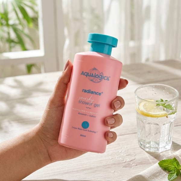 Aqualogica Radiance+ Squishy Shower Gel with Watermelon & Niacinamide for Radiant Skin - 250ml held in hand, candid photo