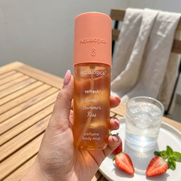 Aqualogica Refresh+ Sweet Summer Kiss Perfume Body Mist with Zemea and Hyaluronic Acid 150 ml held in hand, candid photo