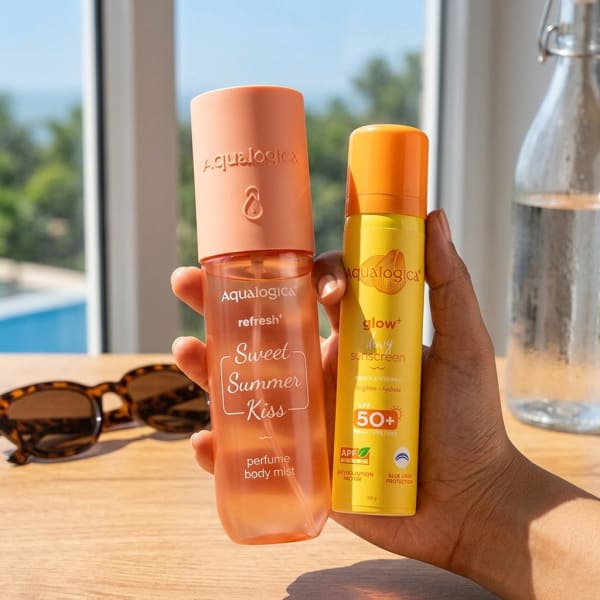 Aqualogica Refresh+ Sweet Summer Kiss Perfume Body Mist & Glow+ Dewy Sunscreen held in hand, candid photo