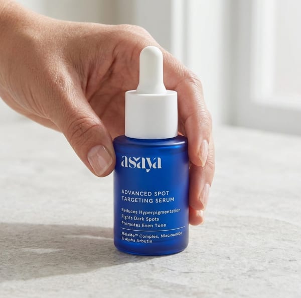 World of Asaya Advanced Spot Targeting Serum held in hand, candid photo