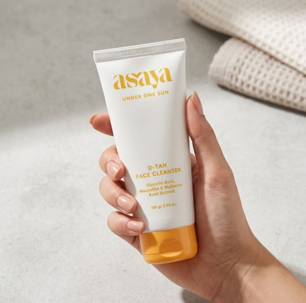 World of Asaya D-Tan Face Cleanser - Tan Removal Facewash for Dull Skin held in hand, candid photo