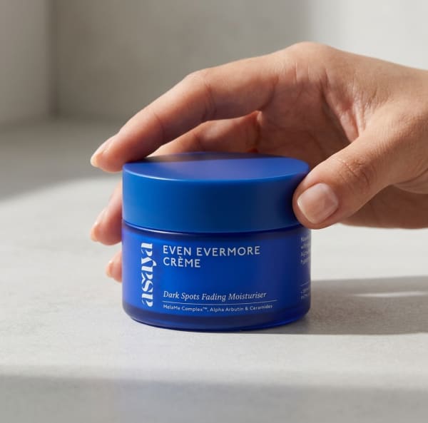 World of Asaya Even Evermore Crème - Moisturizer for Dark Spots & Blemishes held in hand, candid photo