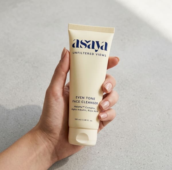 World of Asaya Even Tone Face Cleanser - Face Wash for Dark Spots and Marks held in hand, candid photo