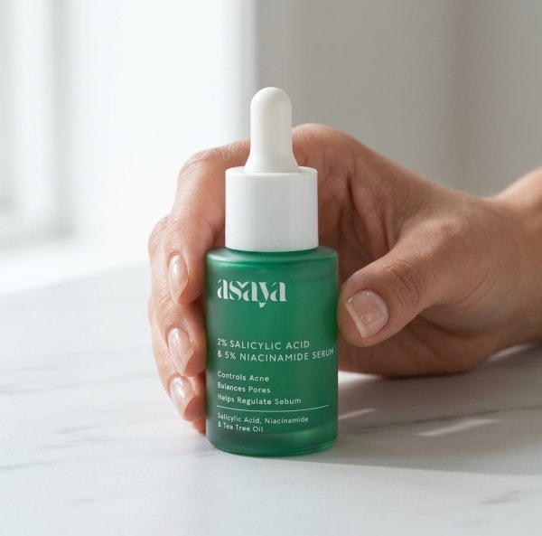 World of Asaya 2% Salicylic Acid & 5% Niacinamide Serum - Reduce Open Pores, Blackheads & Whiteheads held in hand, candid photo