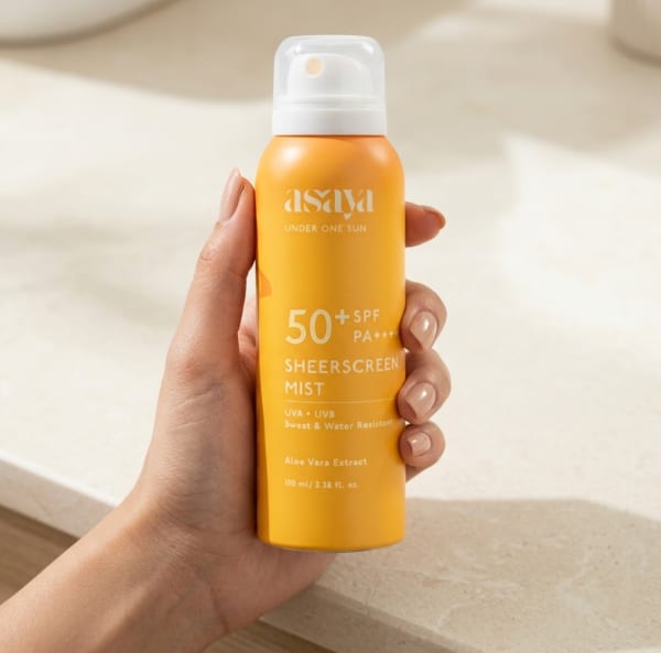 World of Asaya Sheerscreen Mist | Sunscreen Spray SPF 50+ held in hand, candid photo