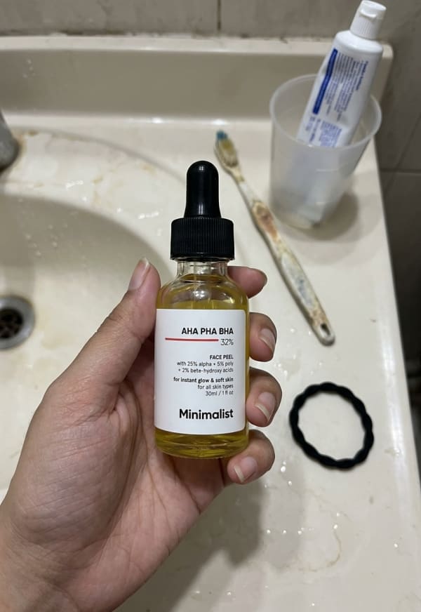 Minimalist AHA PHA BHA 32% Face Peel held in hand, candid photo