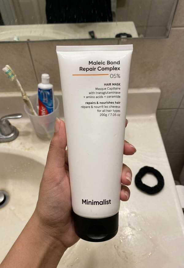 Minimalist Maleic Bond Repair Complex 5% Hair Mask held in hand, candid photo