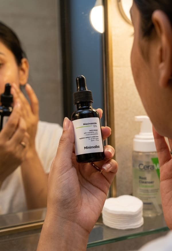 Minimalist Niacinamide 10% Face Serum held in hand, candid photo