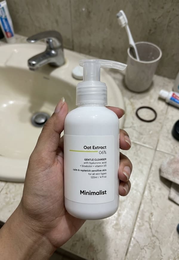 Minimalist Oat Extract 6% Gentle Cleanser held in hand, candid photo
