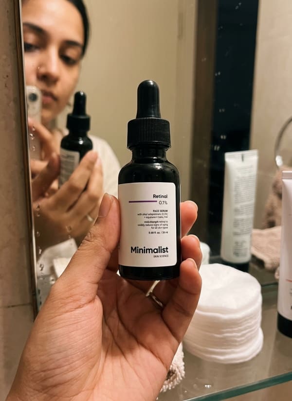 Minimalist Retinal 0.1% Face Serum held in hand, candid photo