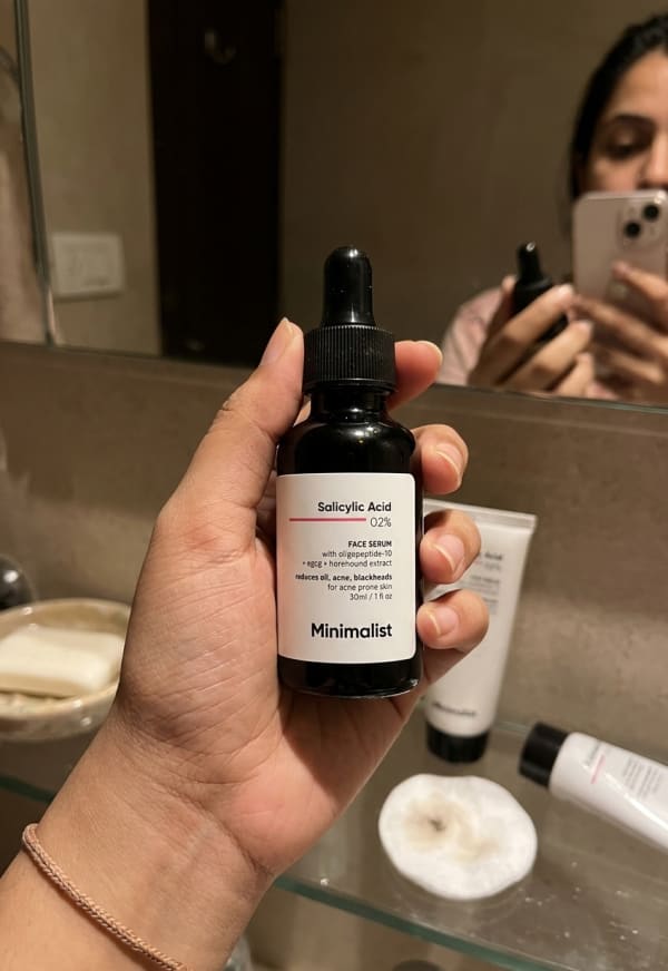Minimalist Salicylic Acid 2% Face Serum held in hand, candid photo