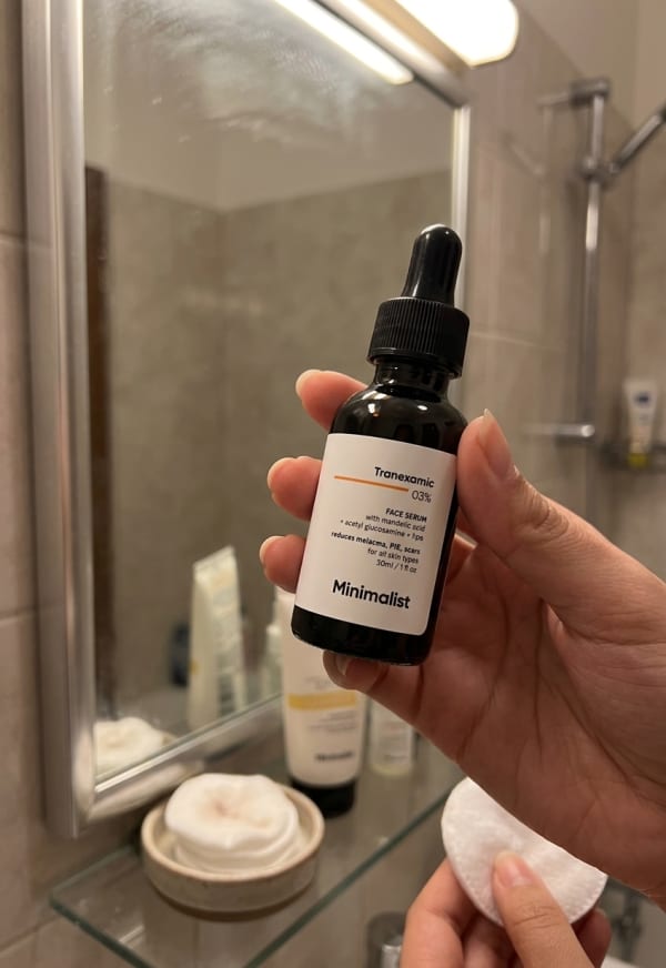 Minimalist Tranexamic 3% Face Serum held in hand, candid photo