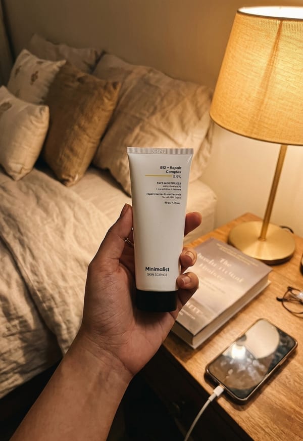 Minimalist B12 + Repair Complex 5.5% Face Moisturizer held in hand, candid photo