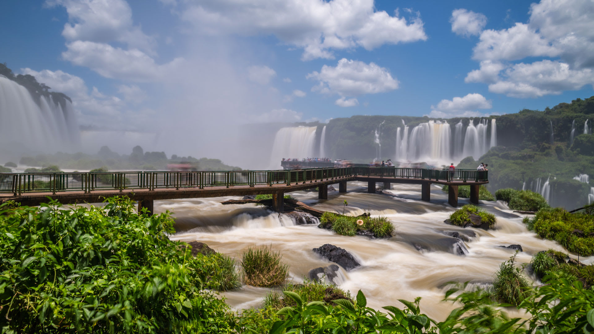 Walkway across the river by the large waterfall