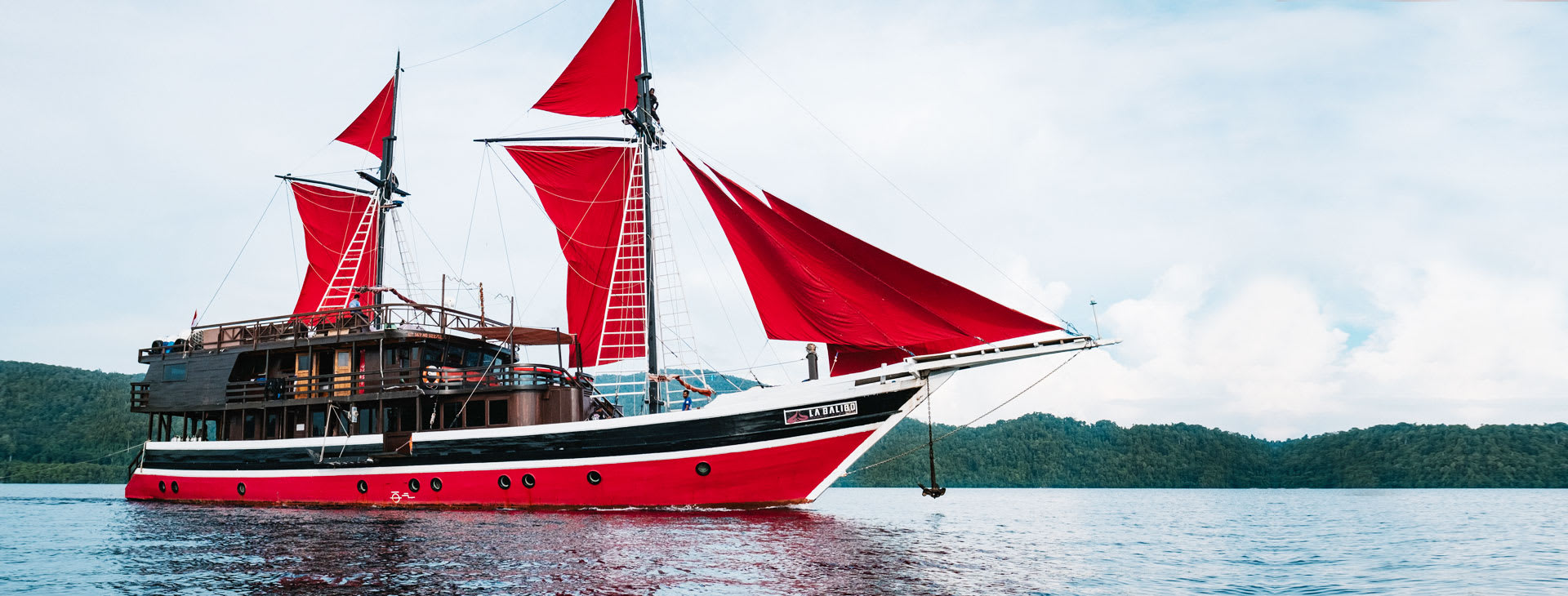 Yacht with red sails