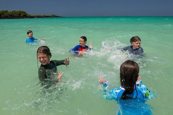 Kids splashing in ocean