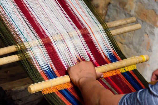 Craftsman weaving on the loom