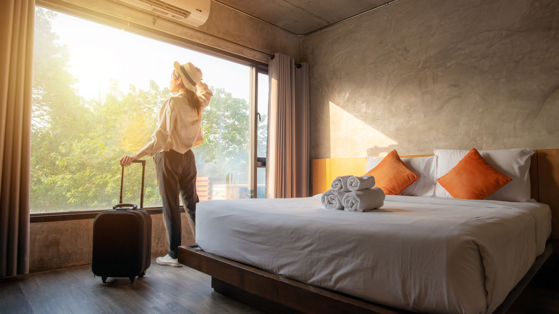 Solo traveler female in front of window at hotel