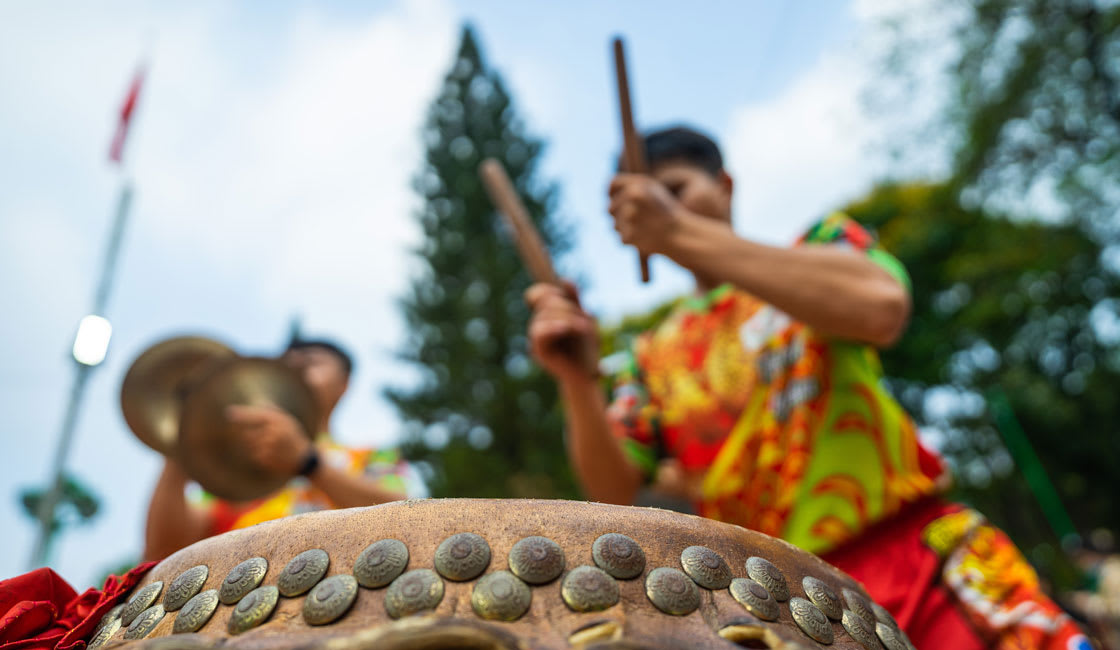 man playing drums in a local festival