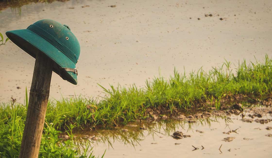 Vietnamese military helmet on a bamboo pole