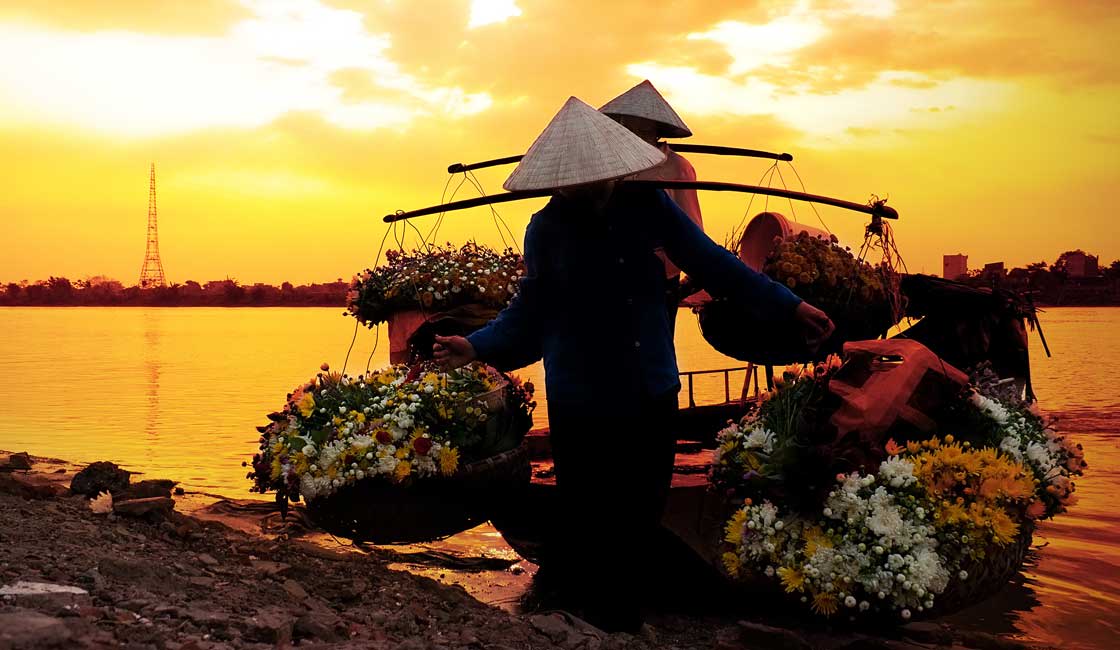 women selling flowers on a boat