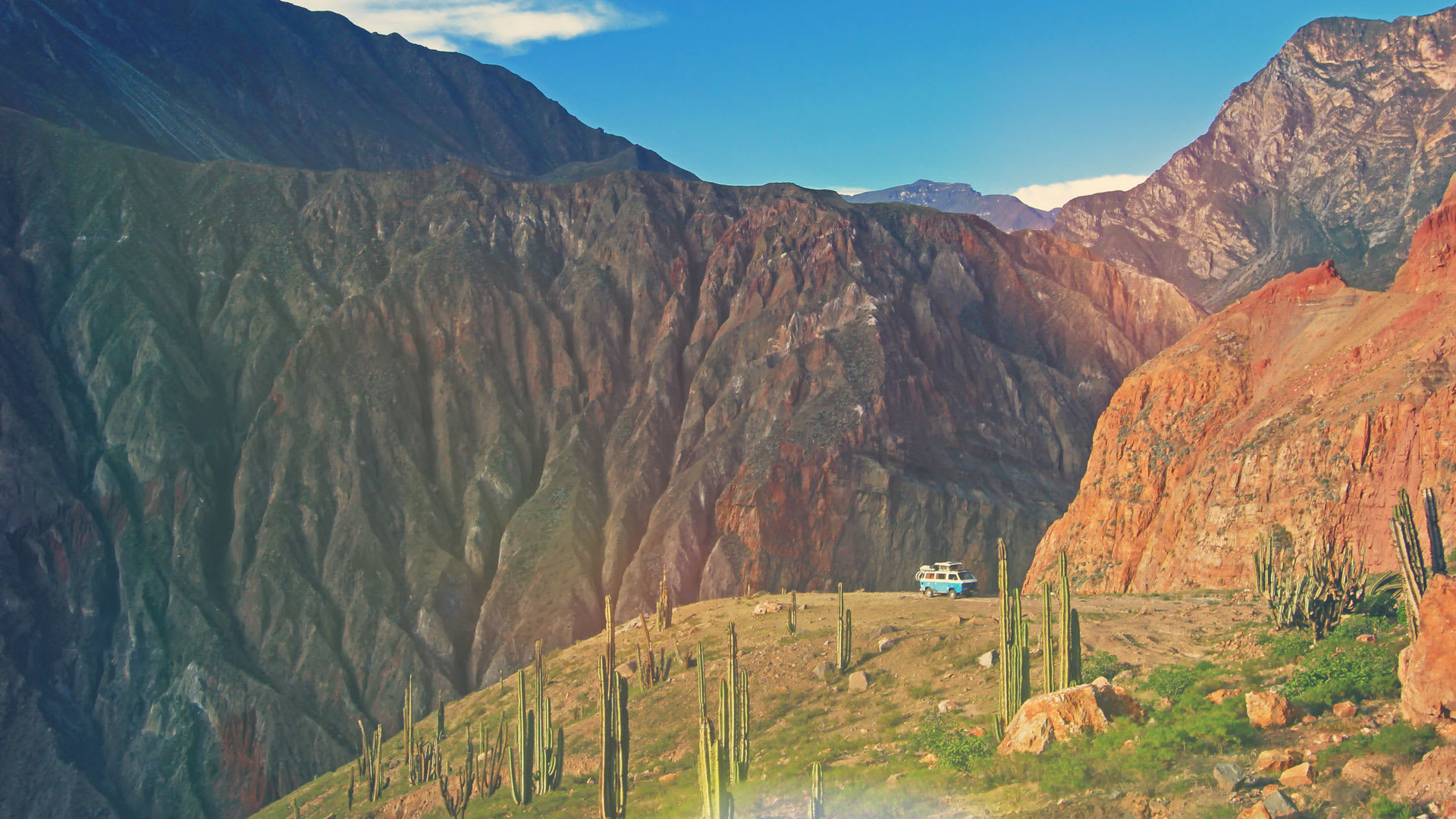 Car surrounded by the high mountains in Cotahuasi