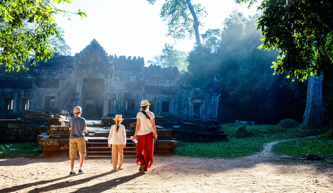 family visiting a temple in cambodia