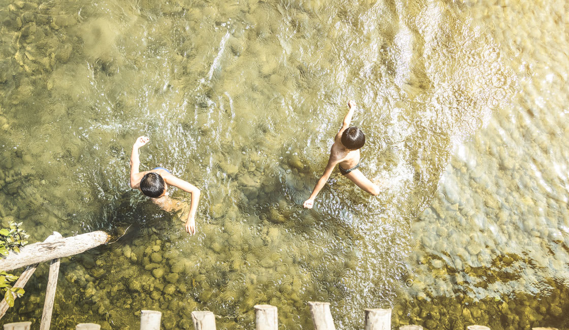 kids playing on the river shore