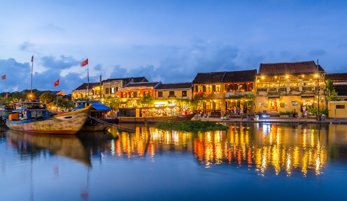 River in Hoi An and reflections of buildings in the evening