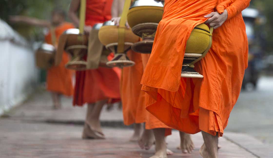 Line of orange-robed monks