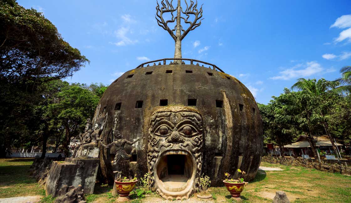 Round stone sculpture with large open mouth