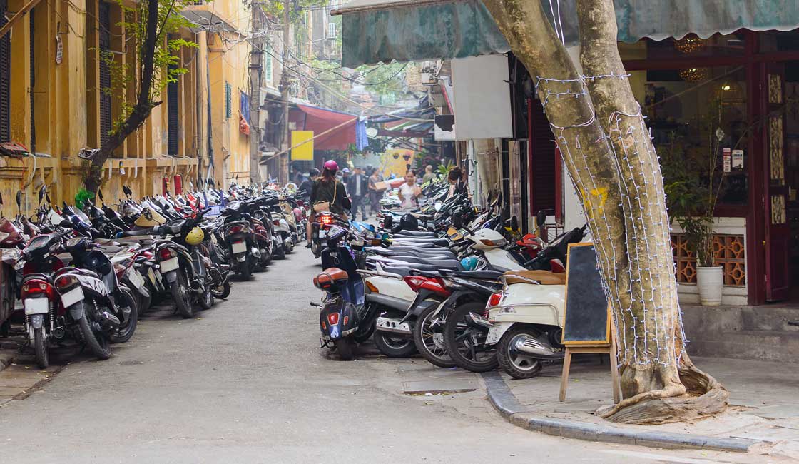 Motorbikes parked on the sidewalk