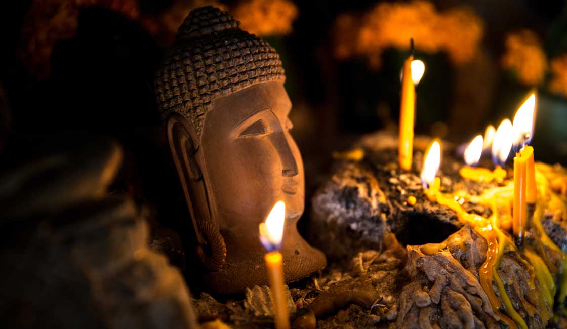 Candles lit by the Buddha head